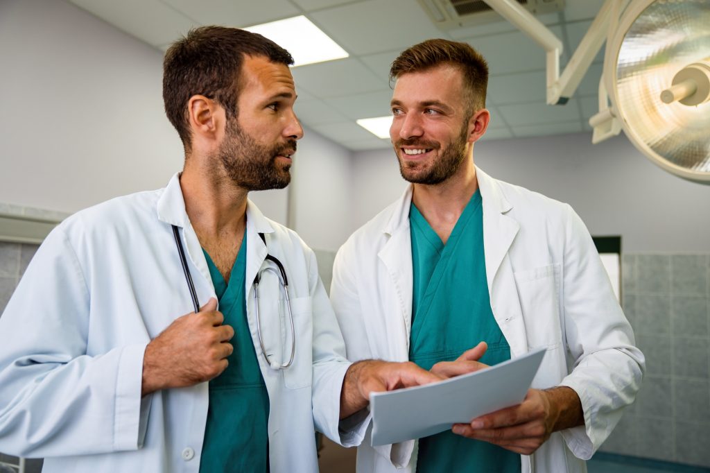 Medical staff having discussion in hospital. Healthcare workers, coronavirus and insurance concept